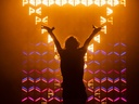 S-TRIBE - wall of fixtures behind a performer